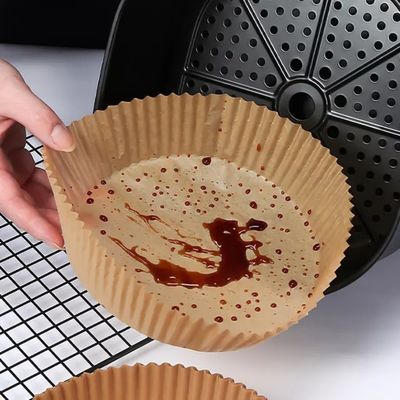 オイル証拠のシリコーンの上塗を施してある空気フライ鍋の硫酸紙の20cm円形の使い捨て可能なベーキング
